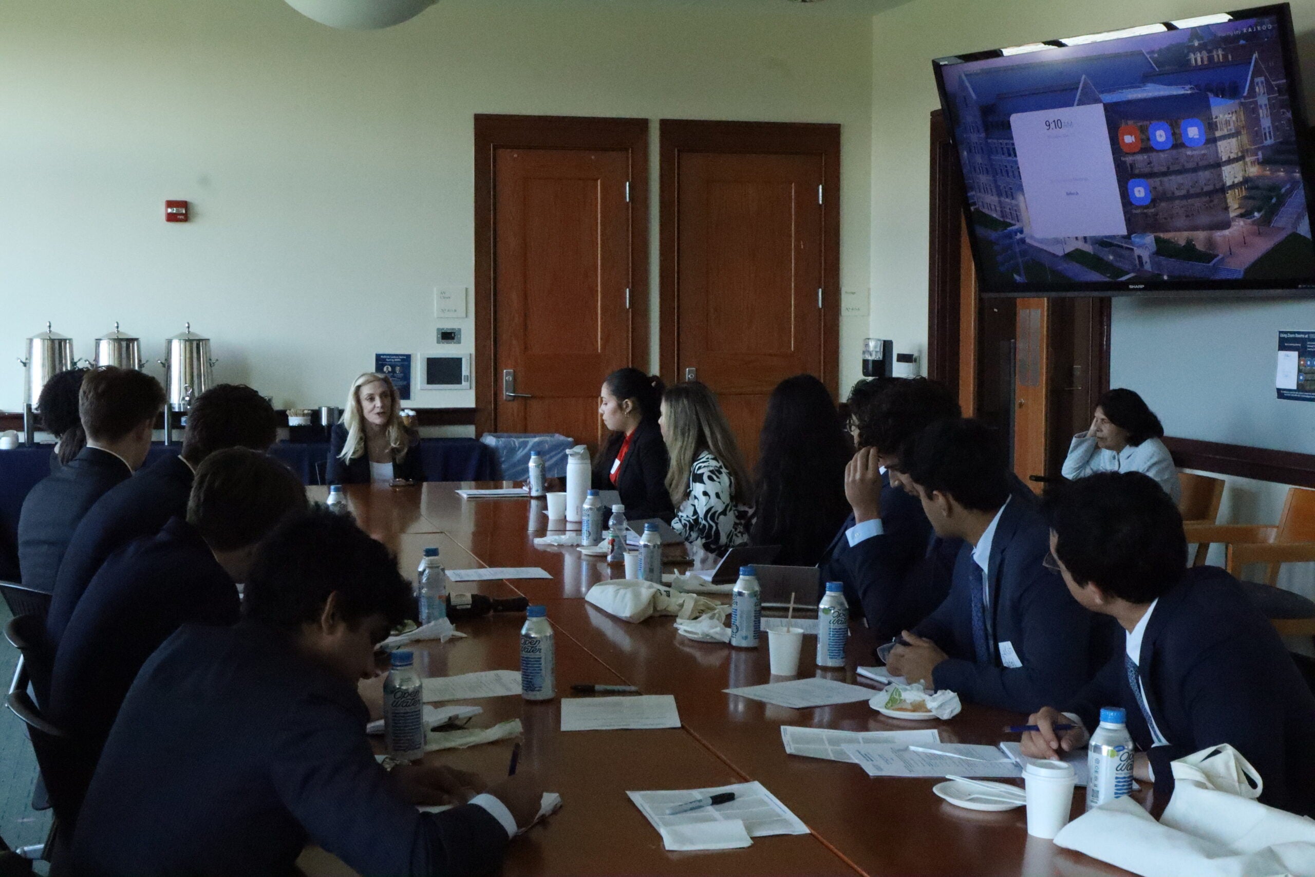 Students around a table with Lael Brainard