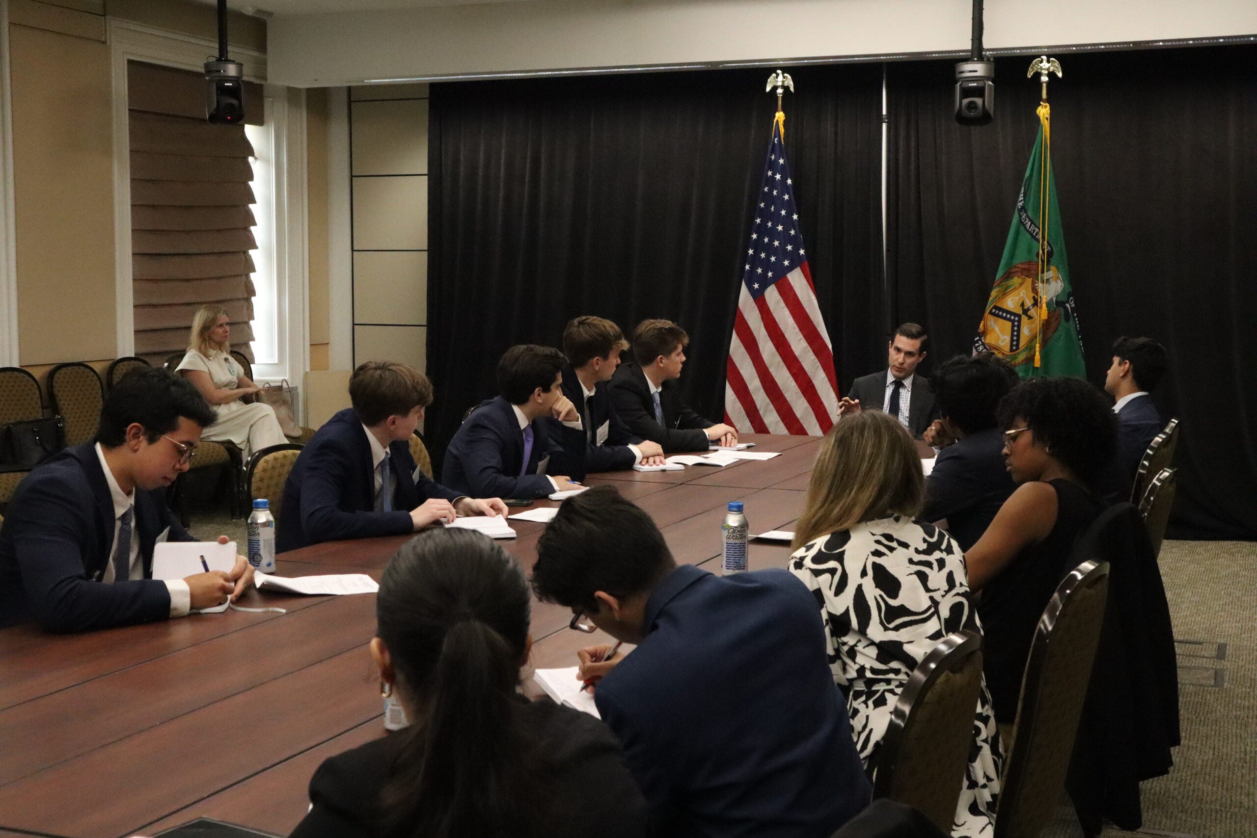 Students in a conference room at the Treasury Department