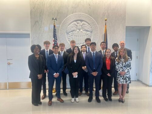 Students in front of the Board of Governors seal