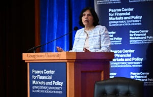 Reena Aggarwal speaking at a podium