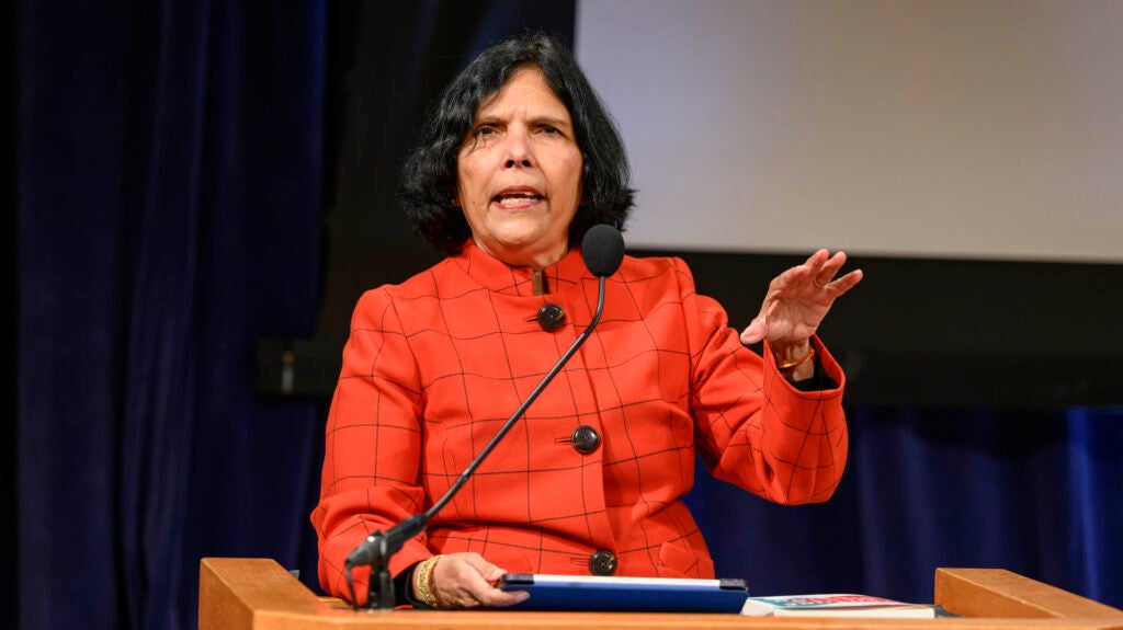 Reena Aggarwal speaking at a podium